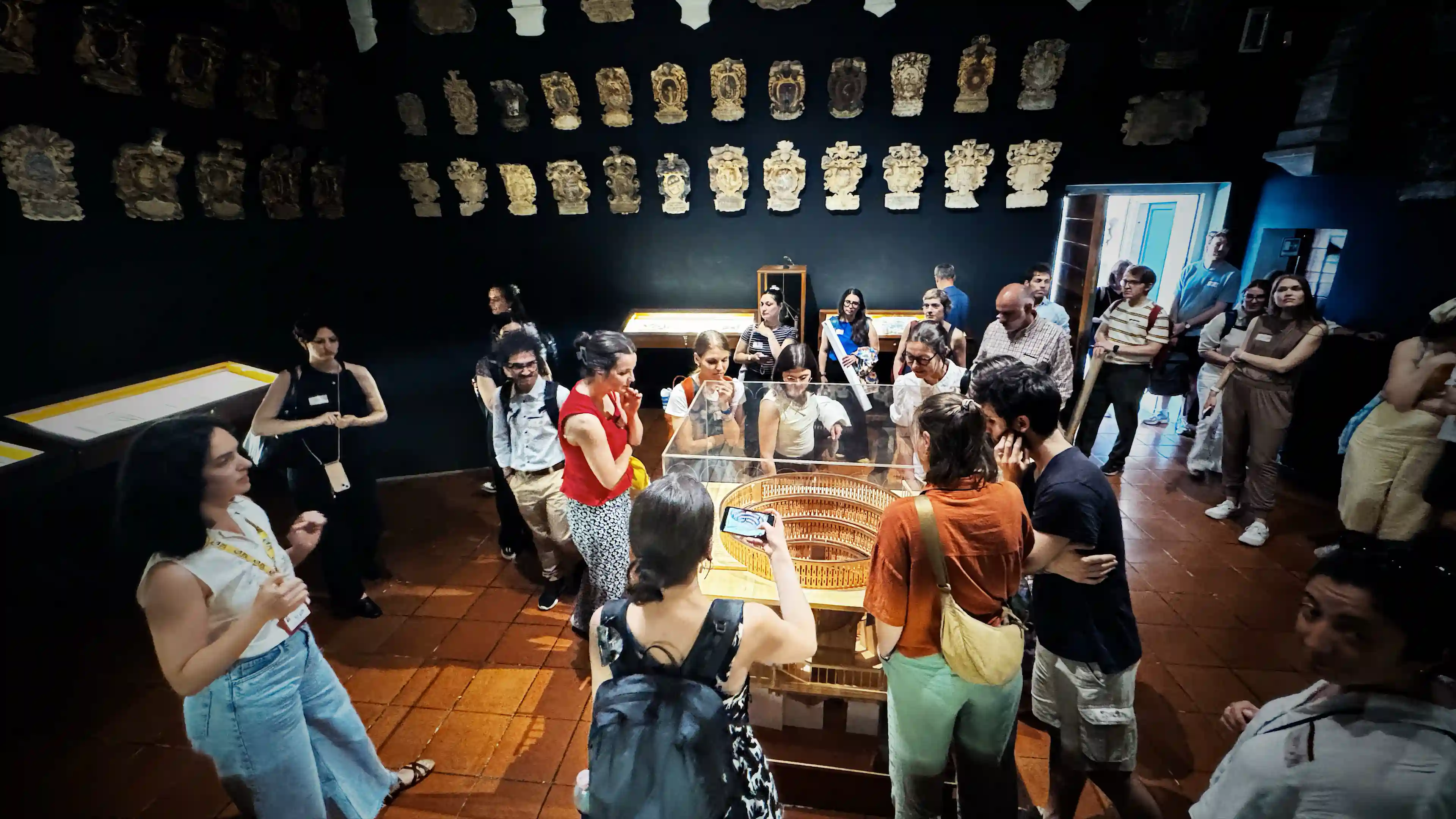 Conference attendees around the scale model of the anatomical theatre at the University of Padova